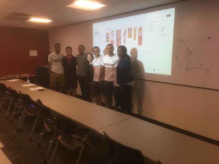 students posing for a picture in front of a whiteboard